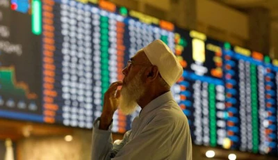 a stock broker reacts while monitoring the market on the electronic board displaying share prices during trading session at the pakistan stock exchange in karachi on july 3 2023 photo reuters