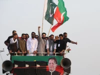 cm afridi raises his fist to supporters during a protest march by pti in bara on the outskirts of peshawar khyber pakhtunkhwa on october 7 2026 photo reuters