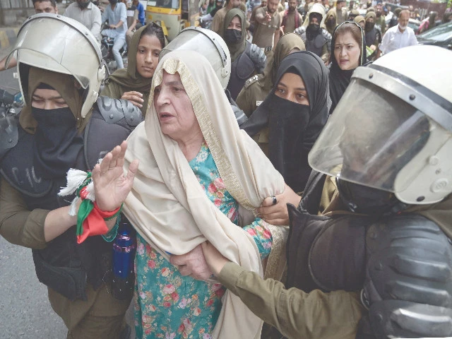 police detain an elderly pti leader during a party protest in lahore photo afp