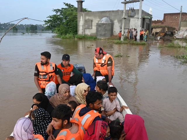 rescuers in a small boat transport residents from the flooded area of narowal a city of punjab on august 27 2025 photo afp rescuers in a small boat transport residents from the flooded area of narowal a city of punjab on august 27 2025 photo afp