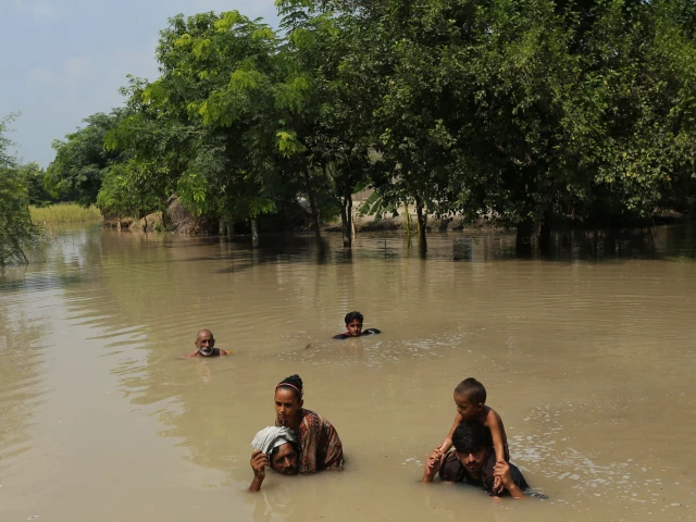 villagers wade through a flooded street following heavy rains at the ehsan pur village in kot addu district of punjab on august 21 2025 photo afp villagers wade through a flooded street following heavy rains at the ehsan pur village in kot addu district of punjab on august 21 2025 photo afp