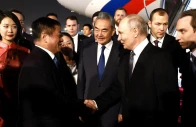 russia s president vladimir putin shakes hands with china s ambassador to russia zhang hanhui as foreign minister wang yi stands nearby during a welcoming ceremony at an airport in beijing china may 19 2026 sputnik via reuters