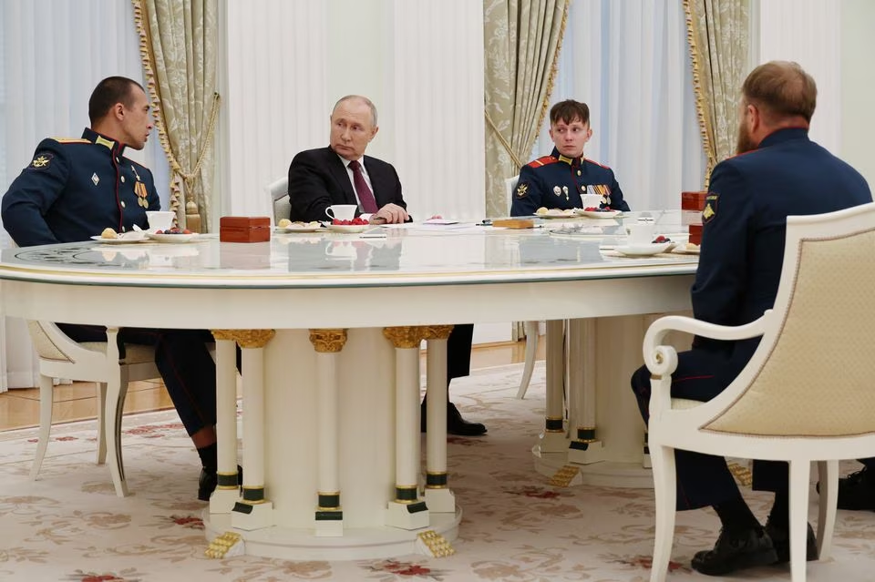 russian president vladimir putin meets with the crew of the alyosha t 80 tank which destroyed a ukrainian armoured convoy on the zaporizhzhia direction in the course of russia ukraine conflict at the kremlin in moscow russia august 24 2023 photo reuters file