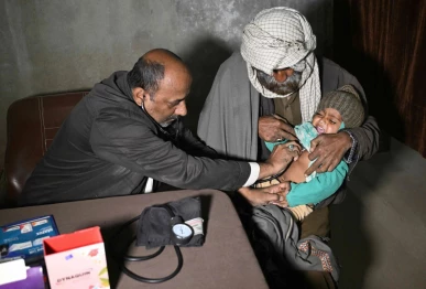 this photograph taken on january 8 2026 shows a quack doctor abdul waheed l trying to diagnose a minor in his unlicensed clinic on the outskirts of hyderabad photo afp