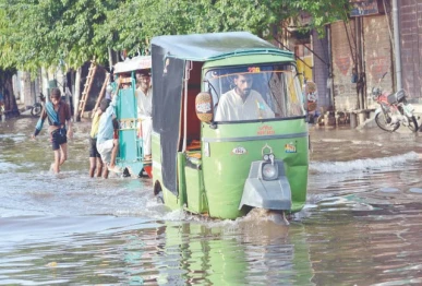 rickshaws pass through rainwater accumulated on makkah road in lahore after a downpour the rain lashed the city for two and a half hours photo app