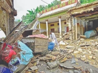 a resident of buner sifts through the mud caked remnants of his home after devastating rains and flash floods photo afp a resident of buner sifts through the mud caked remnants of his home after devastating rains and flash floods photo afp