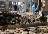 a man clears the rubble of his damaged house collapsed after heavy rains in bannu photo reuters