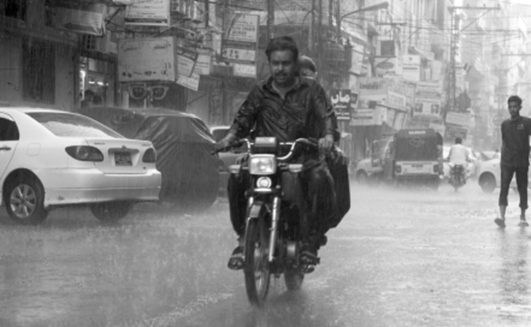 a couple rides on thier bike during rain in hyderabad on friday photo online