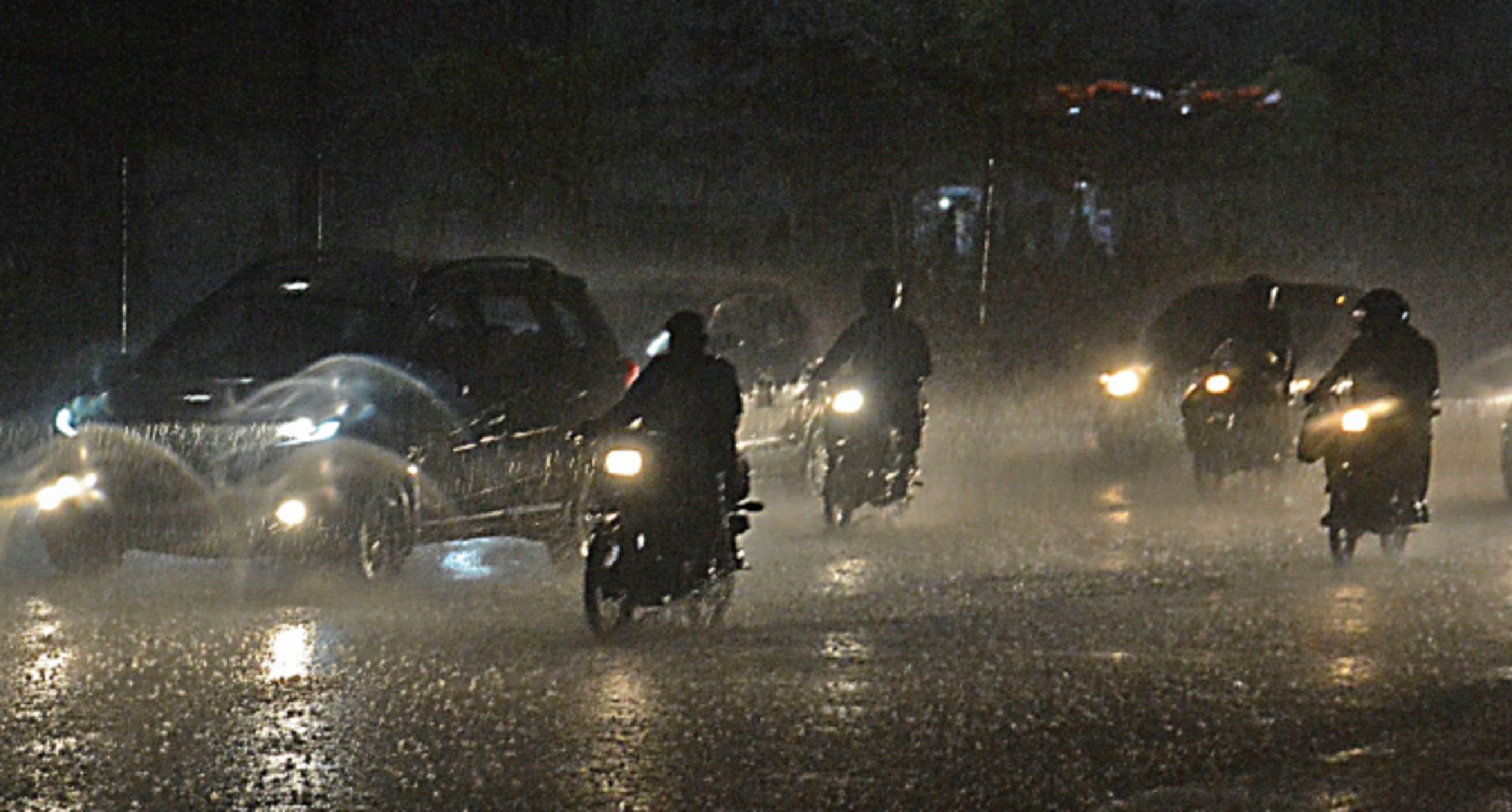 traffic continues to flow on korangi road during the first shower of the rainy season on friday photo jalal qureshi express