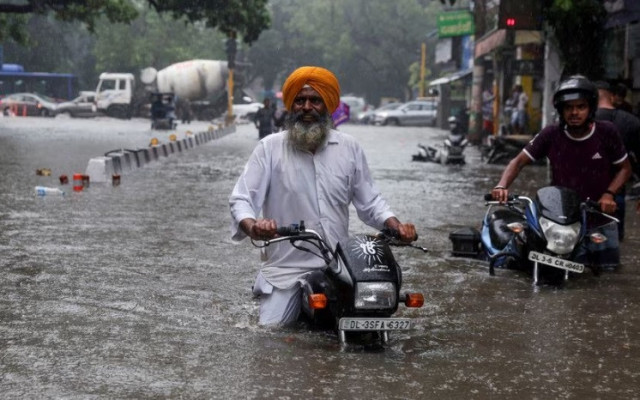a man on his motorbike wades through a flooded street after heavy rains in new delhi india july 8 2023 reuters anushree fadnavis a man on his motorbike wades through a flooded street after heavy rains in new delhi india july 8 2023 reuters anushree fadnavis
