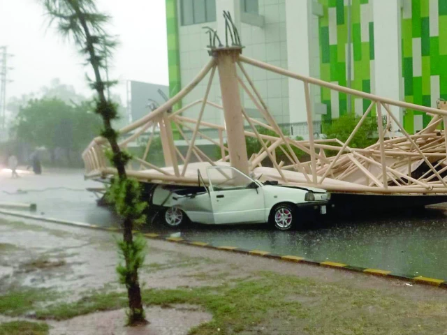 a signboard installed at hayatabad cricket stadium peshawar was uprooted by strong gale and fell on a car parked below luckily no casualty took place as the car had no occupant at the time of incident photo express a signboard installed at hayatabad cricket stadium peshawar was uprooted by strong gale and fell on a car parked below luckily no casualty took place as the car had no occupant at the time of incident photo express