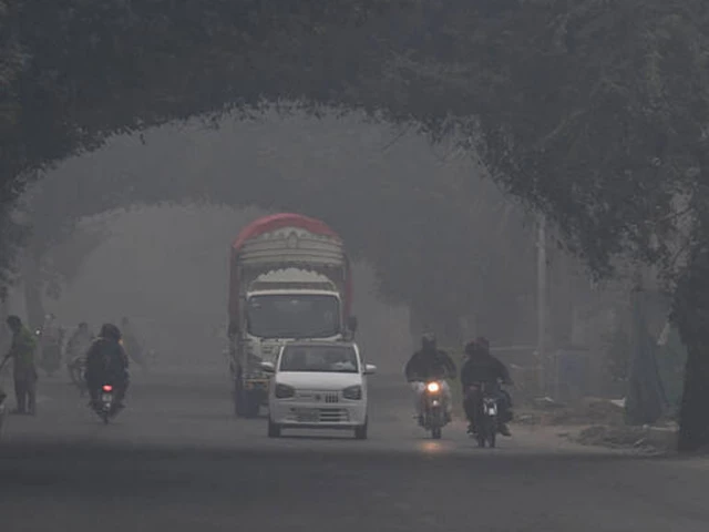 commuters ride along a street amid dense smog in lahore on november 1 2025 photo afp