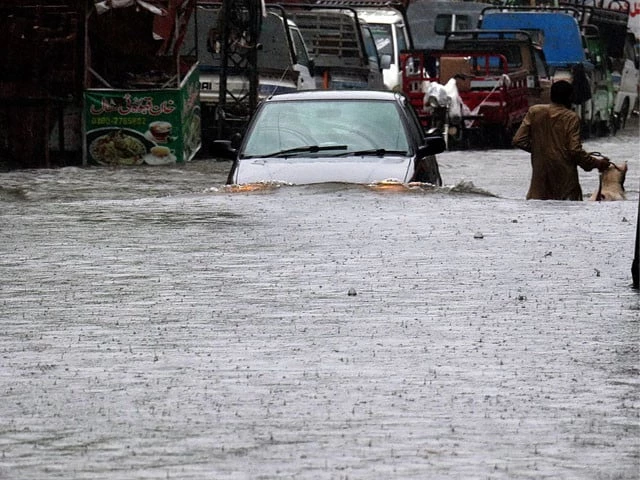 a view of vehicle passing through flooded road during heavy monsoon rains in rawalpindi on july 17 photo inp