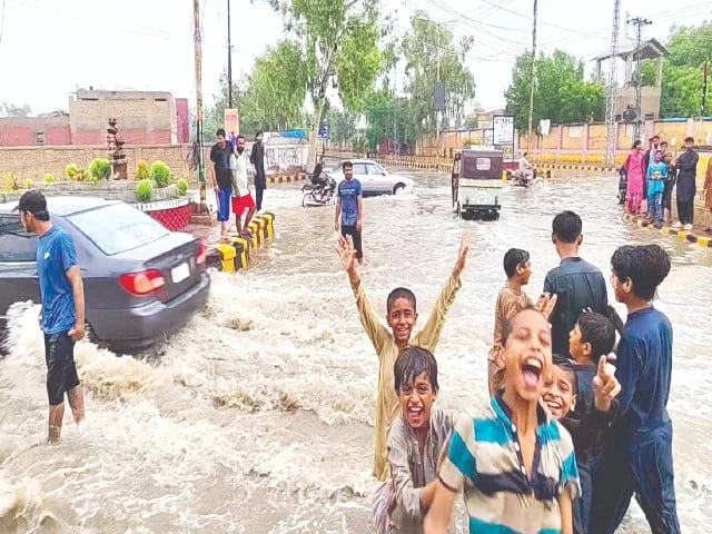 as commuters face difficulties due to stagnant rainwater on the roads children in larkana grin in joy enjoying the weather with their friends photo ppi
