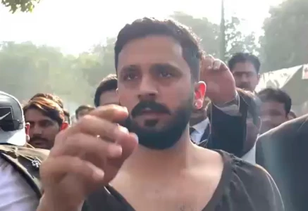 rajab butt being escorted out by his lawyers after the assault source the express tribune