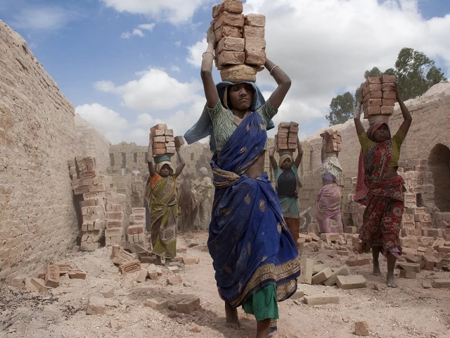 a couple of female kiln workers walk through in extreme summer