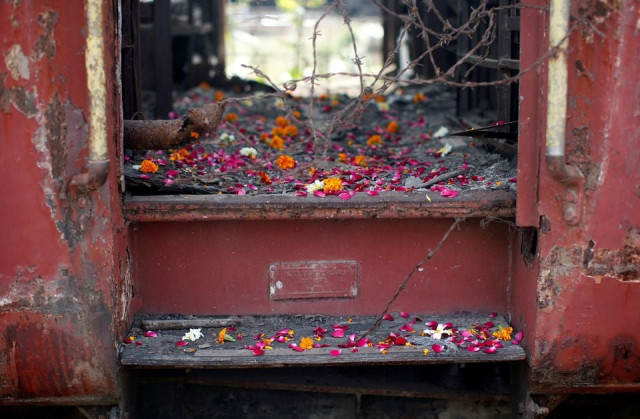 flower petals scattered by the relatives of godhra riots victims are pictured at the doorsteps of a train carriage that was set on fire in 2002 during the commemoration of the 12th anniversary of godhra riots at godhra in the western indian state of gujarat february 27 2014 photo reuters file flower petals scattered by the relatives of godhra riots victims are pictured at the doorsteps of a train carriage that was set on fire in 2002 during the commemoration of the 12th anniversary of godhra riots at godhra in the western indian state of gujarat february 27 2014 photo reuters file