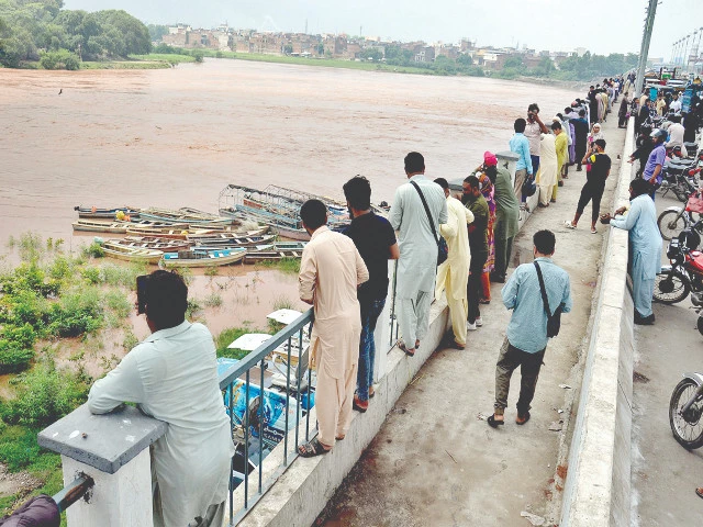 citizens gather at the ravi river bridge in lahore to view floodwater authorities have cautioned residents to avoid travel in areas facing a flood risk photo nni citizens gather at the ravi river bridge in lahore to view floodwater authorities have cautioned residents to avoid travel in areas facing a flood risk photo nni