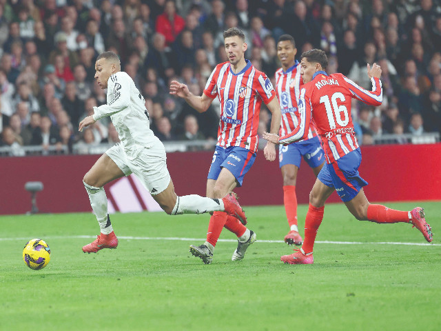 real madrid s kylian mbappe l runs with the ball during the spanish league match against club atletico de madrid at santiago bernabeu stadium in madrid on february 8 photo afp