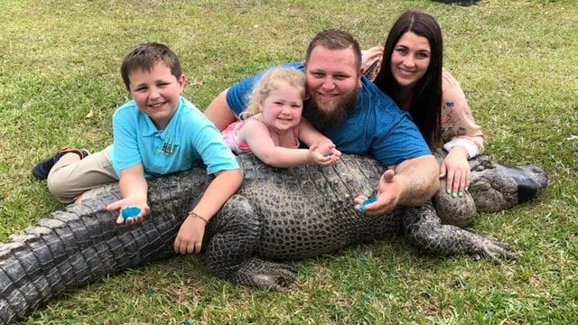couple uses 10 foot long family alligator for gender reveal party of unborn child