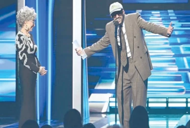 bad bunny speaks as puerto rican actor rita moreno looks on during the billboard latin music awards ceremony in miami photo billboard