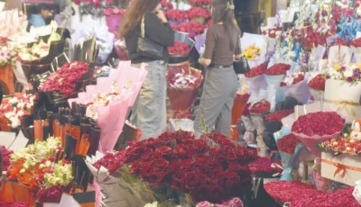 customers throng a flower stall selecting bouquets heart shaped arrangements and gift hampers on valentine s day in the federal capital photo online