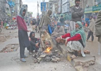 labourers in rawalpindi gather around a fire to keep warm during rainy weather while waiting for customers to hire them for daily wage work to support their families photo online labourers in rawalpindi gather around a fire to keep warm during rainy weather while waiting for customers to hire them for daily wage work to support their families photo online
