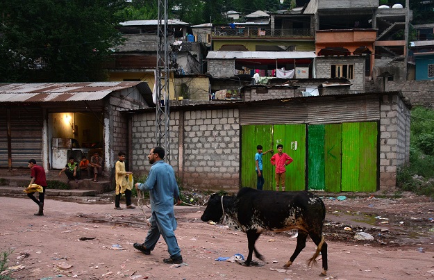 A man walks in the Manak Paiyan refugee camp, where lived many Indian Kashmiri refugees near Muzaffarabad, the capital of Pakistan controlled Kashmir on August 5, 2019. PHOTO: AFP