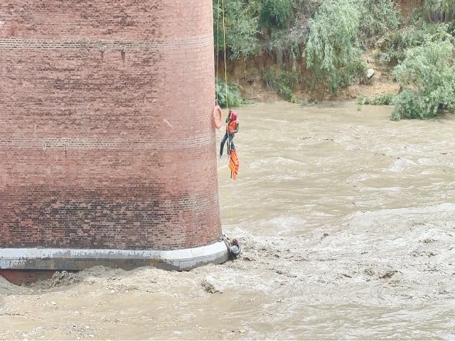 a rescue 1122 worker battles rising floodwaters to save a man swept into the haro river while herding livestock in attock photo nni