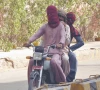 a trio travels on a motorcycle with their heads covered in hyderabad where the mercury rose to 39 c on friday photo ppi