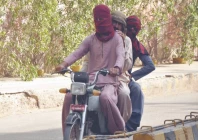 a trio travels on a motorcycle with their heads covered in hyderabad where the mercury rose to 39 c on friday photo ppi