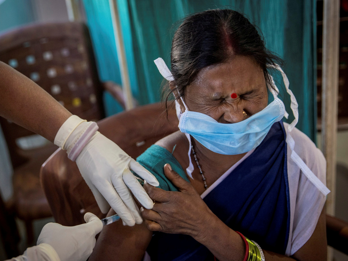 A healthcare worker reacts as she receives a dose of COVISHIELD, a COVID-19 vaccine manufactured by Serum Institute of India, during one of the world's largest COVID-19 vaccination campaigns at Mathalput Community Health Centre in Koraput district of the eastern state of Odisha, India, January 16, 2021. REUTERS