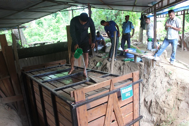 This picture taken on July 10, 2018, shows a wildlife official pouring water onto a crate carrying a one-horned rhinoceros to be loaded onto a truck as it is being sent to China as a gift. PHOTO: AFP