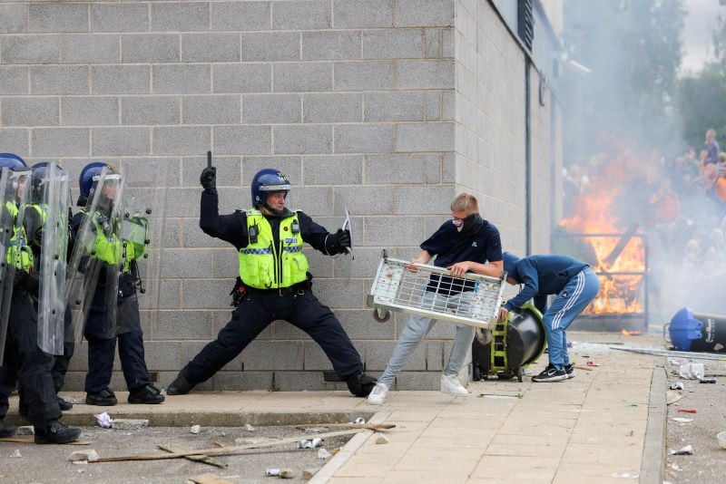 angry protester clashing with police in uk photo reuters