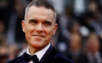 robbie williams breaks uk chart record previously held by the beatles
