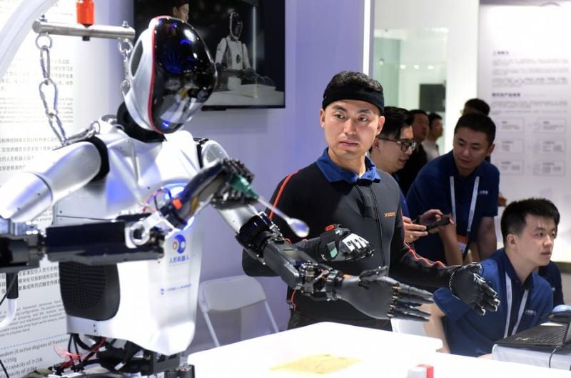 a staff member demonstrates a gesture controlled robot during the 2024 world ai conference in shanghai east china july 4 2024 photo xinhua