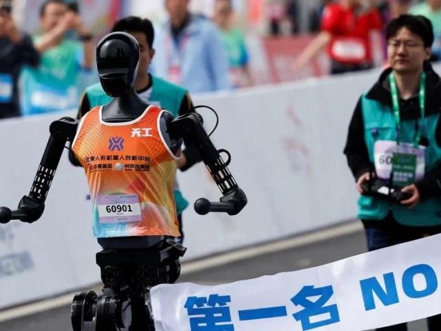humanoid robot tiangong participates along with human runners in the e town half marathon humanoid robot half marathon in beijing china april 19 2025 photo reuters