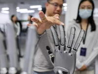 a man touches a robotic hand displayed at the demonstration area at the office of linkerbot in beijing china april 27 2026 reuters