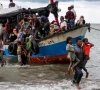 locals evacuate rohingya refugees from a boat that came ashore on the north coast of indonesia s sumatra island in june 2020 photo reuters