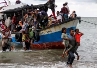 locals evacuate rohingya refugees from a boat that came ashore on the north coast of indonesia s sumatra island in june 2020 photo reuters