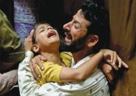 grieved a father and daughter mourn the loss of family members who were killed when the roof of their home collapsed in lahore photo reuters