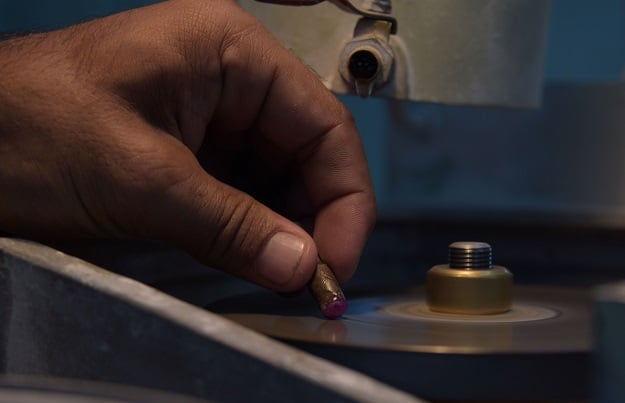 a Pakistani student curving the shape of a gemstone at the Gems & Jewerllery Training & Processing Centre in Muzaffarabad. PHOTO: AFP