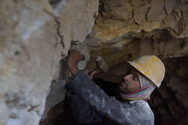 a Pakistani labourer Muhammad Azeem removing pieces of rock after blasting at a mountain to find gemstones in the Kashmiri town of Chitta Katha in Upper Neelum Valley. PHOTO: AFP