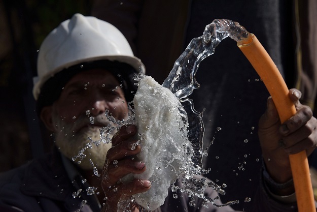 An elderly Pakistani labourer washing a piece of rock outside a mine at a mountain to find gemstones in the Kashmiri town of Chitta Katha in Upper Neelum Valley. PHOTO: AFP