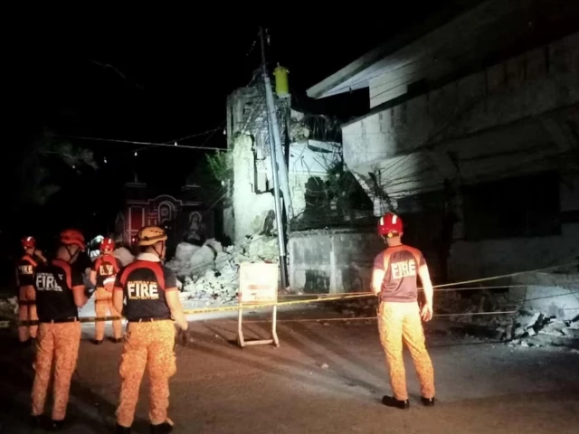 rumi rescue personnel stand in front of a damaged structure following a 6 9 magnitude earthquake in daanbantayan cebu province philippines october 1 2025 photo reuters