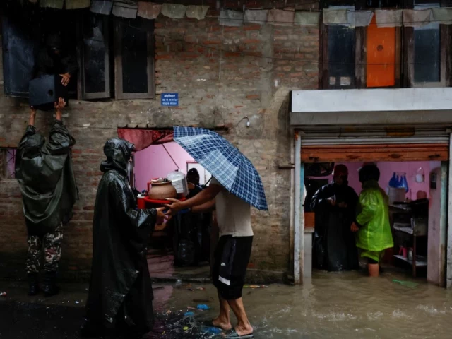 members of nepal army help people retrieve their belongings to a safe area at a flooded street along the bank of overflowing bagmati river following heavy rains photo reuters