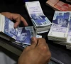 an employee counts pakistani rupee notes at a bank in peshawar on august 22 2023 photo reuters