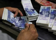 an employee counts pakistani rupee notes at a bank in peshawar on august 22 2023 photo reuters
