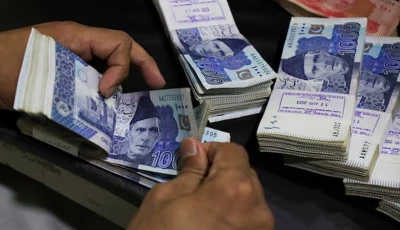 an employee counts pakistani rupee notes at a bank in peshawar on august 22 2023 photo reuters