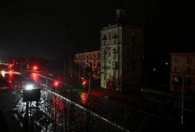 cars move along a dark street during a power blackout after a russian drone strike in ukraine s zaporizhzhia on january 7 2026 photo afp